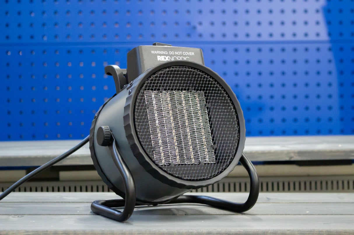 REX NORDIC HEAT 3000 fan heater on a workshop bench, front view