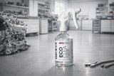 REX EcoCleaner spray bottle in a workshop next to an engine