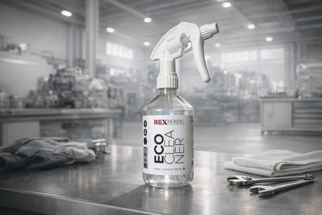 REX EcoCleaner spray bottle on a workbench with cloths and wrenches