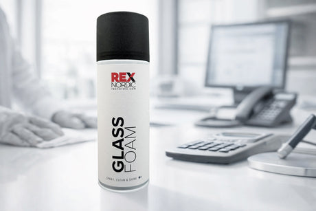 REX GlassFoam cleaner on an office desk with phone and calculator
